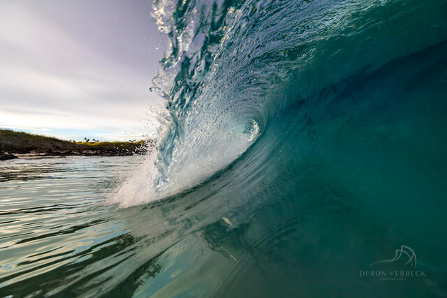 Wave photography image by Deron Verbeck Photography captures a turquoise blue wave just before it crashes. 