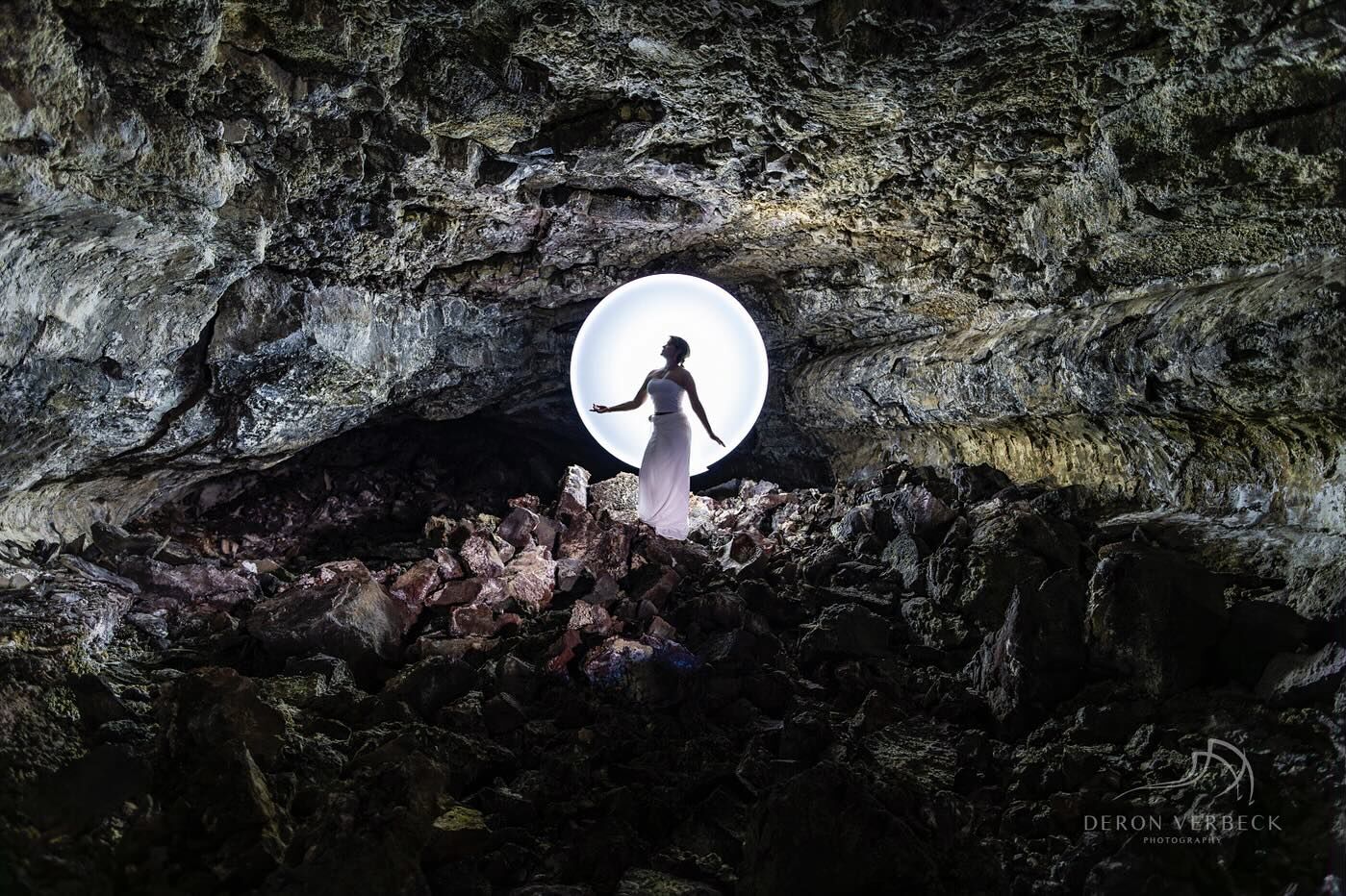 Woman in a lava tube with a circle of light from light painting photoshoot